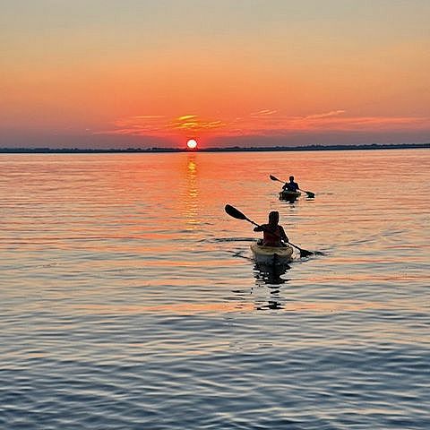 kayakers at sunset